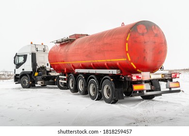 Oil tanker truck with a red tank semi-trailer on a winter road. The picture was taken in Russia in winter - Shutterstock ID 1818259457