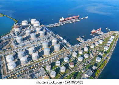 Oil terminal with a pier and a moored ship aerial view. Industrial landscape at sunny day