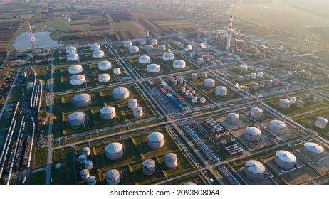 Oil terminal for storage of oil and petrochemical products at sunset. Aerial on the Oil Refinery Industrial Facility. Refinery factory oil storage tank and pipeline, Ecosystem and healthy environment.