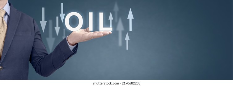 Oil Trend. Energy Crisis With Stock Market. Current Change In Price Of Barrel Of Oil. Usinessman Showing Word Oil And Arrow Up And Down. Wide Blue Banner