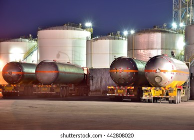 The oil truck tankers in the refinery background in the evening
