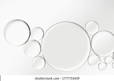 Oil And Water Droplets Created Bubbles An Art Image On Grey-silver Background.