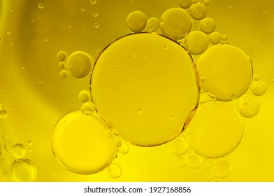 Oil in water emulsion, greasy drops and abstract backgrounds concept with fat droplets forming bubbles due to surface tension on yellow background - Shutterstock ID 1927168856