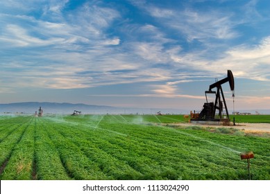 Oil Well, Pump Jack, In The San Joaquin Valley Of Central California At Sunset. Oil Industry Background. 