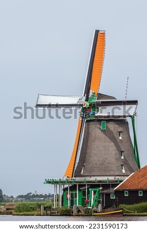 The oil windmill called The Seeker at the Zaanse Schans in Zaandam. The mill blades show some motion blur