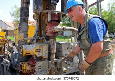 Oil Worker Drilling For Oil On Rig. Portrait Of An Oil Worker With Tool In His Hands.
Worker Operating Machinery On Oil Rig. Oil And Gas Industry. Selective Focus.