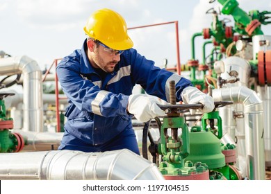 Oil Worker Is Turning Valve On The Oil Pipeline