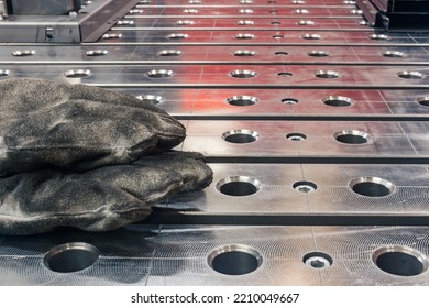 Oiled Burnt Work Gloves Of A Welder Left On The Welding Table Close-up