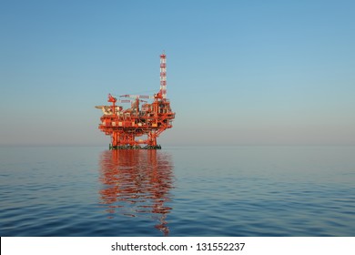 oilrig lit by the rising sun