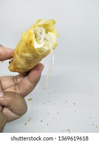 Oily Hand Open Holding Delicious Indonesian Traditional Snack  Cake Street Or Gorengan Lumpia Spring Roll, Fried Wheat Dough Filled Vegetable Vermicelli Egg Fritter. Homemade Isolated White Background