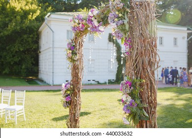 Oiser Wedding Altar With Crystals Stands In The Sunshine On A Backyard