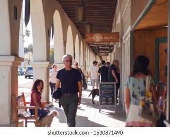 Ojai, CA / United States - October 12 2019: A day in the sun at the Ojai Days festival. Store fronts with tourist checking out the different spots. 