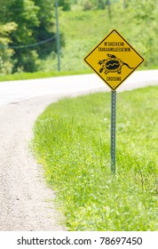 Ojibwa Language Turtle Crossing Sign On The Side Of A Highway On Manitoulin Island, Canada In The Early Summer.