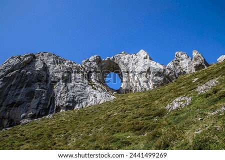 Ojo de Buey is an imposing natural rock arch located on one of the best-known peaks in the region: Peña Mea, located at 1,557 meters high. Aller, Asturias, Spain.