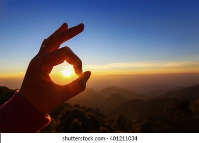 Ok hand sign silhouette at sunrise. On blue sky background - Powered by Shutterstock