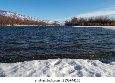 The Okanagan River In The Winter Surrounded By Snow And Mountains In Osoyoo, BC, Canada