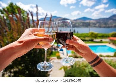 Okanagan Valley Wine Tasting Tour, Wineries Visit During Summer And Spring Vacations Concept, Man And Woman Hands Toasting Red And White Wine Glasses