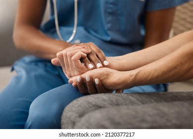 Its okay if youre not feeling okay. Shot of a doctor holding hands with her patient during a consultation at home. - Powered by Shutterstock