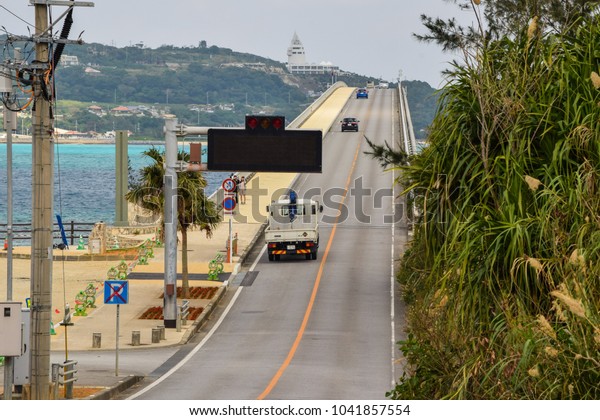 Okinawa, Japan. December 2017 -\
Cars going over the hump of Kouri Bridge in Okinawa Prefecture,\
Japan