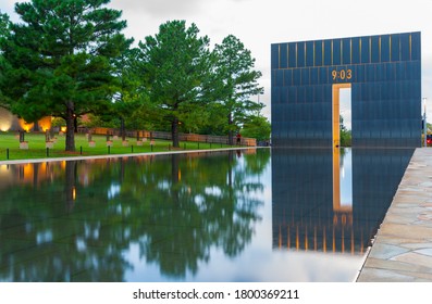 Oklahoma City USA - September 9 2015; Oklahoma National Memorial Gate Of Time And Reflecting Pool With Field Of Empty Chairs Under Trees On Left.