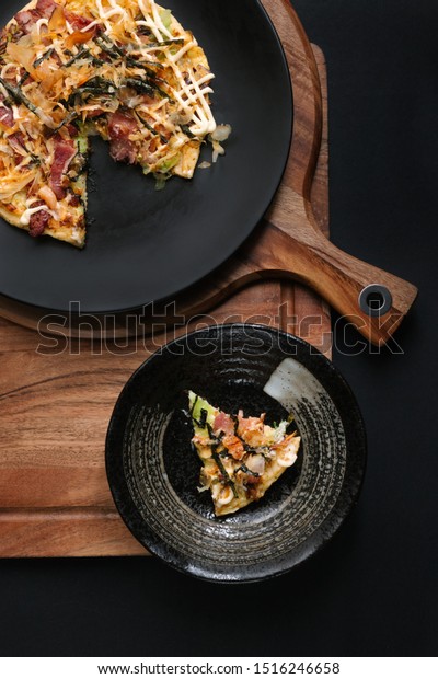 Okonomiyaki (Japanese pancake) homemade cuisine\
(with cabbage and\
bacon)