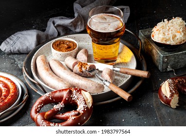 Oktoberfest Beer With Grilled Weisswurst White Sausages, Bavarian Pretzels And Mustard Sauce. Ideas, Recipes How To Celebrate The Beer Festival 2020 At Home