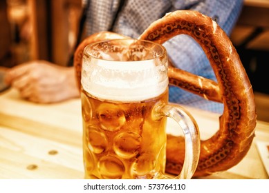 Oktoberfest Beer And Pretzel On Wooden Table