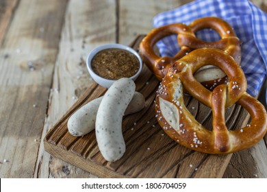 Oktoberfest food. Bavarian meal . White sausages, brezel and sweet mustard on wooden table
