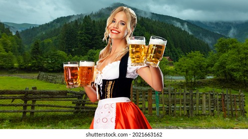 Oktoberfest Girl Waitress With Beer. Woman Wearing A Traditional Bavarian Or German Dirndl On Octoberfest, Serving Big Mugs With Drink On Mountains Background.