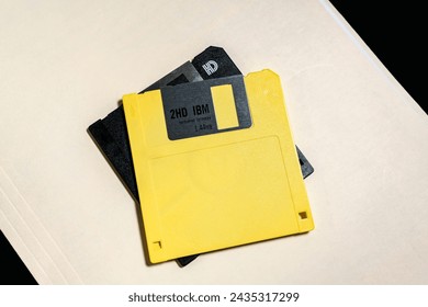 Old 3 and a half inch floppy disks on a manila folder