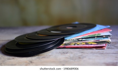 old 45 rpm vinyls dusty and worn by time	