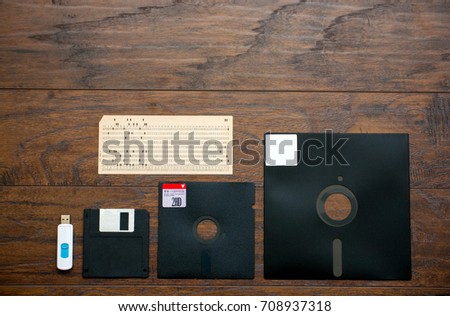 The old 8-inch, 5.25-inch, 3.5-inch floppy disk, punched card for an old ibm computer, a comparison with the USB flash drive