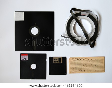 The old 8-inch floppy disk, magnetic tape for an old computer, punched card