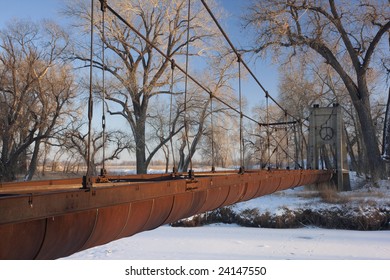 Old Abandoned Aqueduct (irrigation Ditch) Suspended Across A River In Colorado Farmland, Winter Scenery