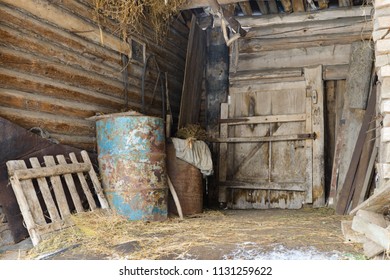 old abandoned barn with metal barrels and old things