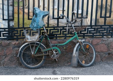 An old abandoned bicycle near the fence - Powered by Shutterstock