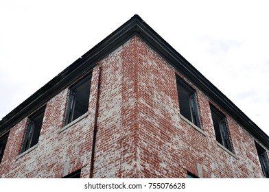 Old abandoned big brick building with broken windows