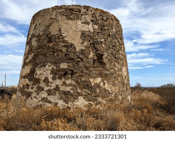 old abandoned brick windmill on hill in algarve, portugal, europe (historic, antique, ruin, ruined, travel) faded, dilapidated, rustic, monument, tower