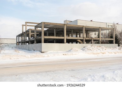 An Old Abandoned Building Site Surrounded By A Fence. Winter