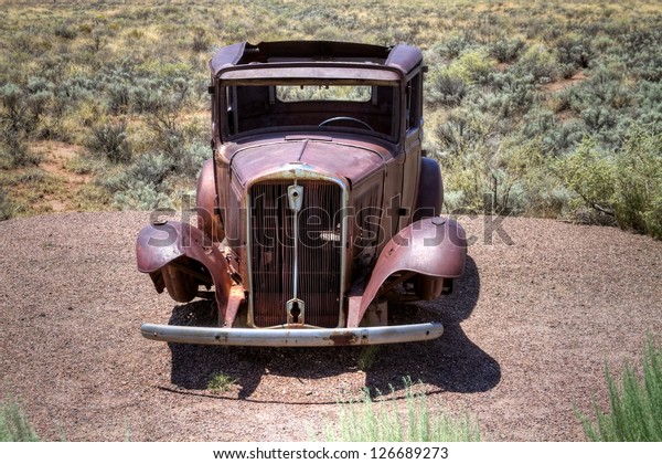 Old abandoned car in the\
desert