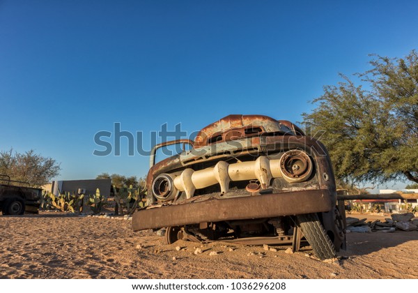 Old and abandoned car in\
the desert of Namibia. Solitaire. With the beautiful light of the\
sunrise.