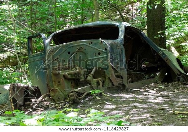 Old Abandoned Car in the\
Forest