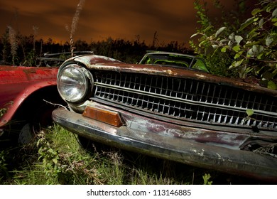 Old Abandoned Car In A Junkyard At Night Light Painted