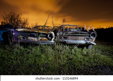 Old Abandoned Car In A Junkyard At Night Light Painted