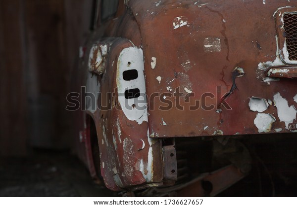 an old\
abandoned car standing in a car\
cemetery