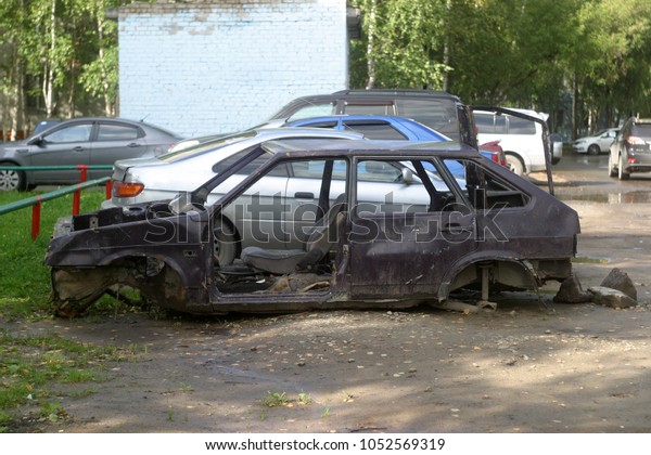 An old abandoned car in\
the yard 