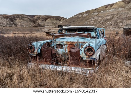 Old abandoned cars in the badlands of Alberta. 