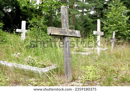 Old abandoned cemetery with wooden crosses in Pape, Latvia