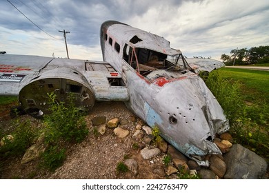 Old abandoned crashed plane in fields on cloudy day