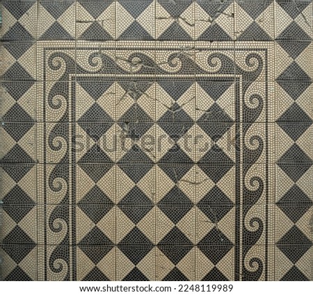 Old abandoned floor with decorative tiles of the 19th century with wave-like pattern.